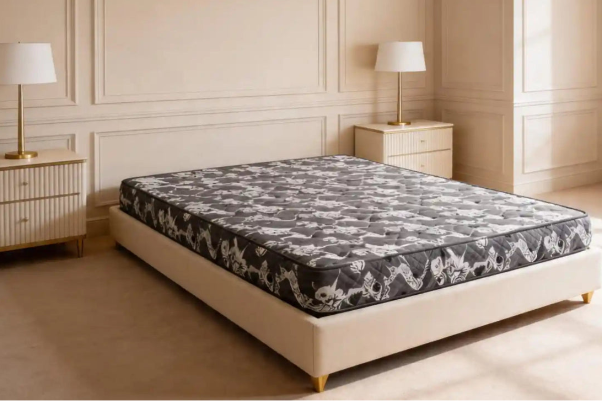 Mattress on a bed in a bedroom with two lamps and nightstands.